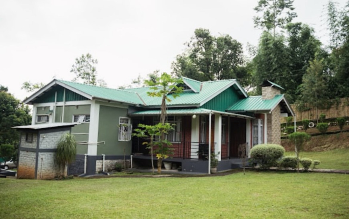 Vallenea Guest House with a green roof, brick chimney and spacious garden